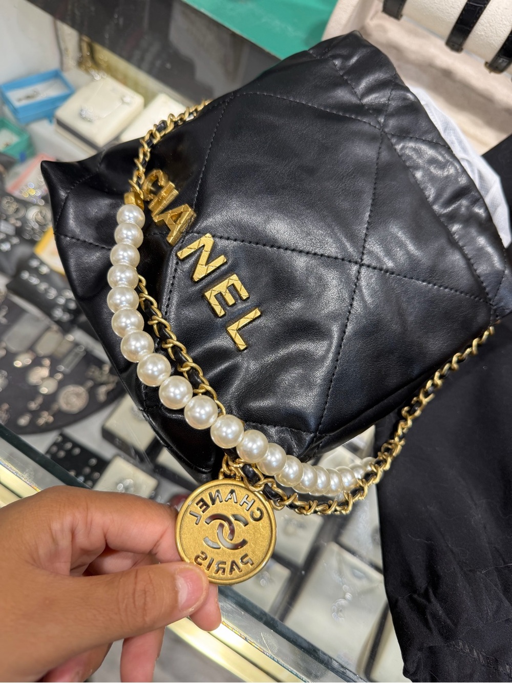 CHANEL Black Quilted Leather Mini Bag with Gold Hardware and Pearl Chain